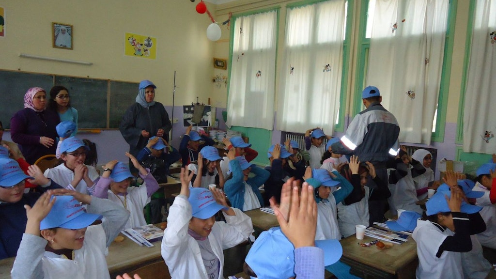 Primary class in Morocco with students wearing blue caps