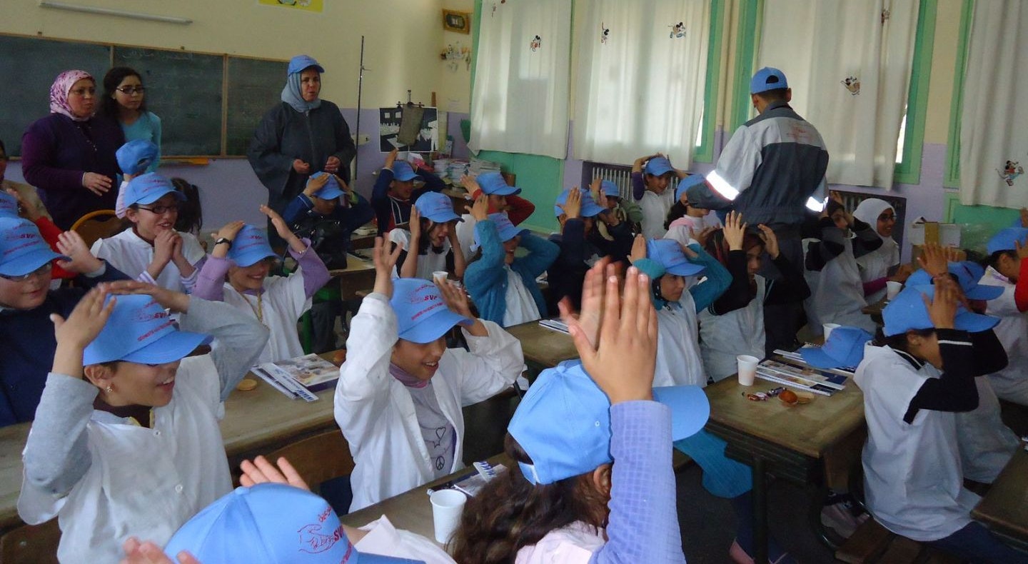 Primary class in Morocco with students wearing blue caps